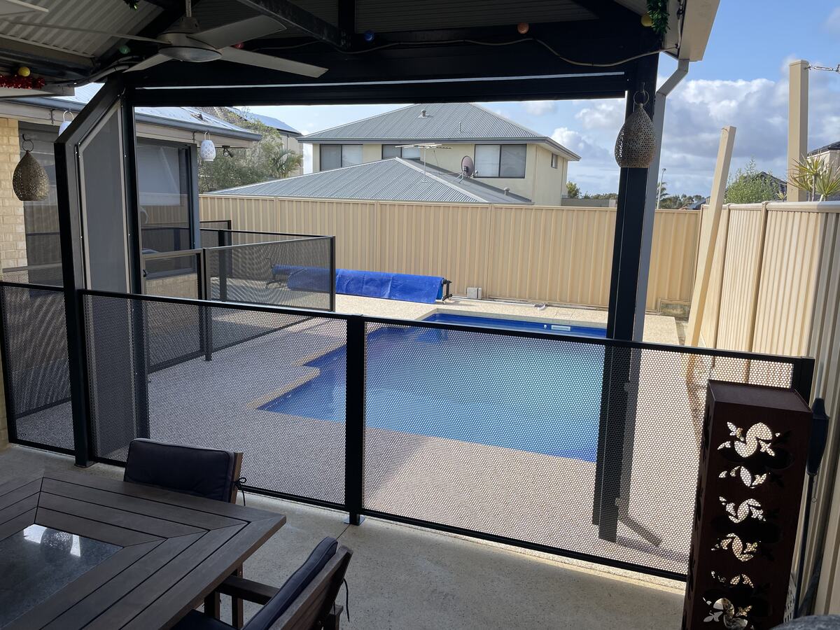 Pure Perf pool fence in Textured Black beside a blue pool, Perth